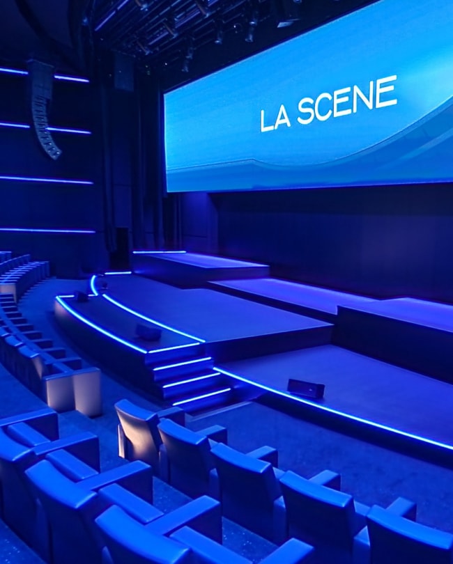 Empty auditorium of The Stage: blue tiered seating and 22-metre LED wall