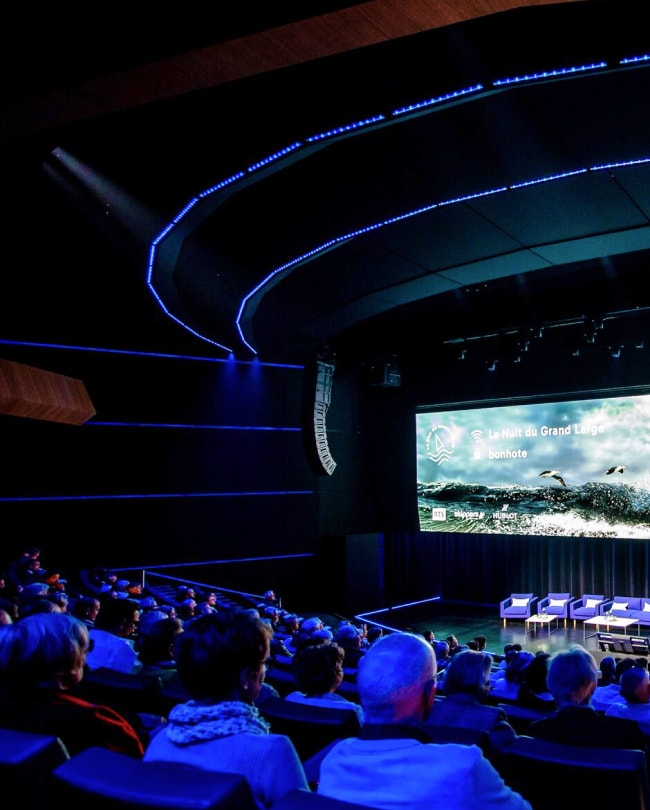 Audience seated in The Stage facing the LED wall before a conference