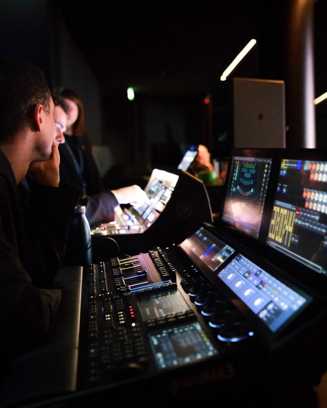 Technician at the sound and lighting console during a conference