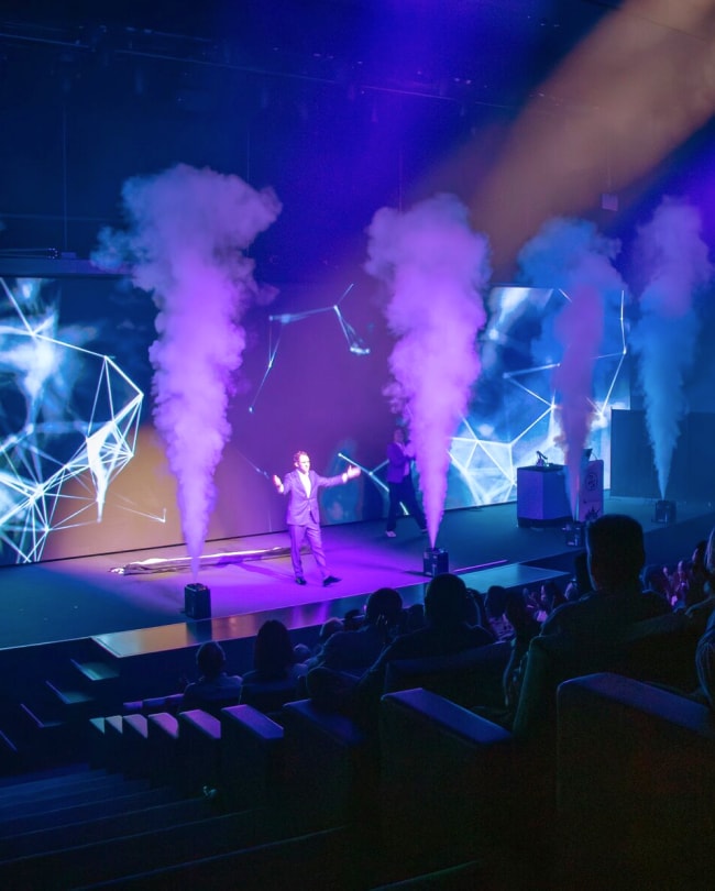 Speaker in The Stage between CO2 jets, with the LED wall behind