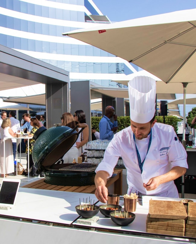 Chef grilling skewers on the barbecue on the Brasserie terrace